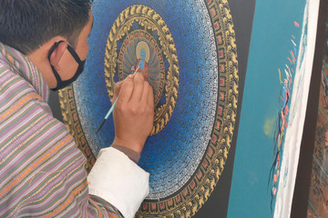 Wall Mural - Artist works on a traditional mandala