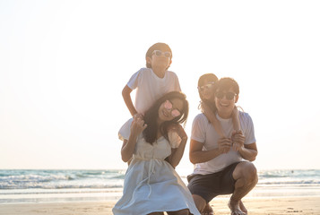 Portrait Asian Family in the beach with kids happy vacation concept.