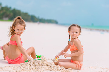 adorable little girls during summer vacation on the beach