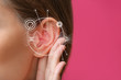 © Pixel-Shot - Young woman with hearing problem on color background, closeup