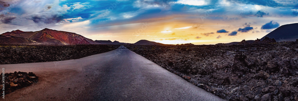 Image related to unexplored road journeys and adventures.Road through the scenic landscape to the destination in Timanfaya natural park in Lanzarote,Canary island,Spain - obrazy, fototapety, plakaty 