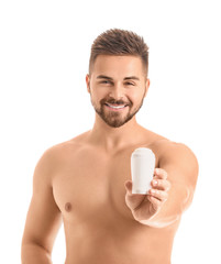 Handsome young man with deodorant on white background