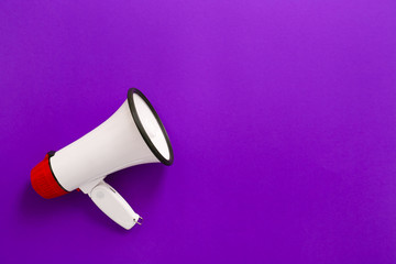 Modern megaphone on color background