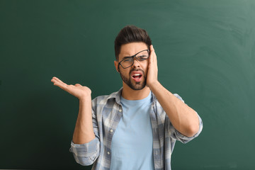 Sticker - Stressed teacher near blackboard in classroom