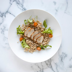 Poster - Sliced Pork Tenderloin and Wholegrain Salad on a Marble Background with room for Copy