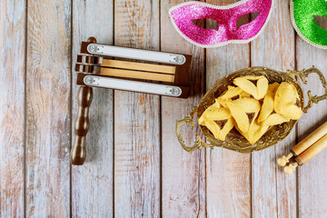 Jewish holiday Purim with hamantaschen cookies hamans ears, carnival mask and parchment