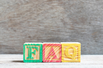 Poster - Color letter block in word FAQ (Abbreviation of Frequently Asked Questions) on wood background