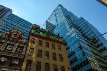 Wall Mural - Modern skyscrapers and old building on city street