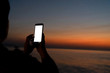 © Suphansa - Mock up smart phone with sunset.  Holiday concept