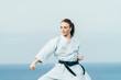© Mikel Taboada - Young redhead female karate athlete training outdoor.