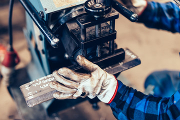 Wall Mural - Manual steel plate bevelling process in a factory, workshop