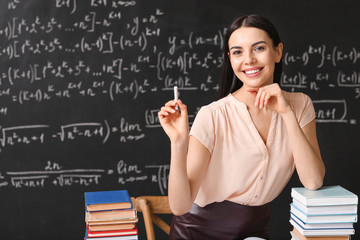 Wall Mural - Female teacher at workplace in classroom