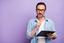 Portrait Of Interested Man Job Worker Hold Clip Board Want Write Thoughts Think Touch Pencil Chin Look Copyspace Wear Casual Style Clothes Isolated Over Purple Color Background