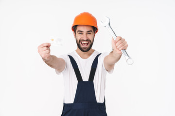 Sticker - Happy young man holding credit card and wrench.