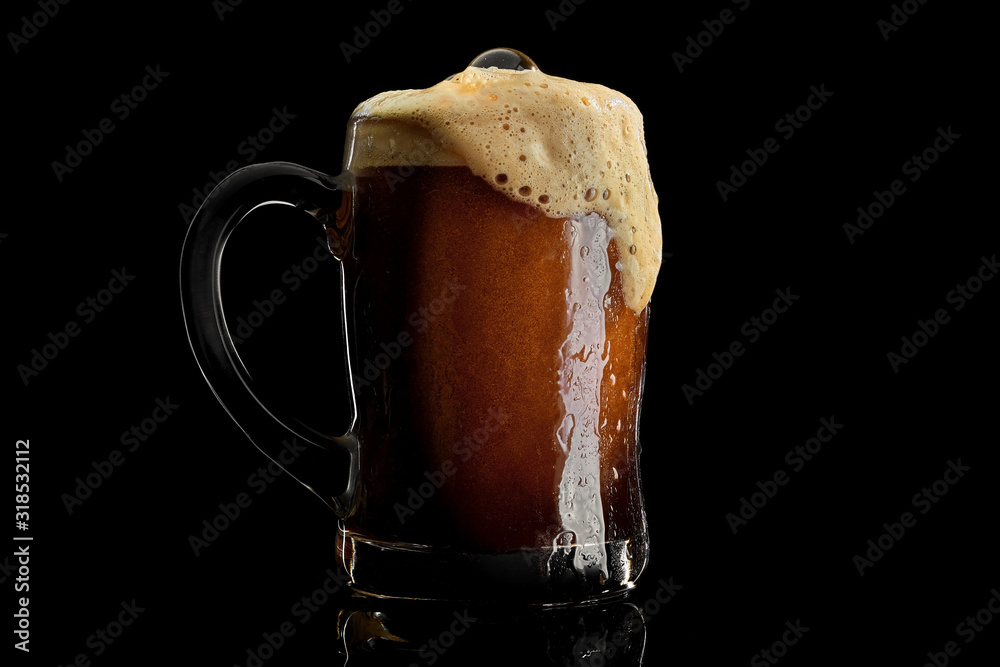 Cold beer mug with black stout covered with drops and froth studio shot on black background. - obrazy, fototapety, plakaty 