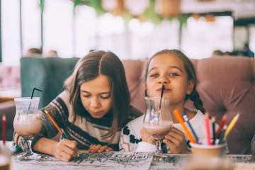 children drink smoothie in family cafe