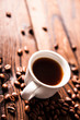Cup of hot fresh black coffee on vintage wooden table