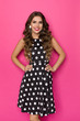 © studioloco - Cute Happy Woman In Black Coctail Dress Is Posing With Hands On Hip