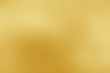 Gold metal texture background. Golden shiny metallic plate textured flat surface with smooth light reflection