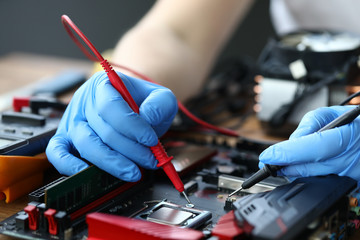 Male hand in blue protective gloves repair and upgrade desktop pc closeup background. Fast help system install service concept