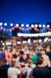 © astrosystem - Blurred large group of people with de-focused lights.