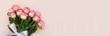 Banner 3:1. Bouquet Of Fresh Pink Roses Wrapped Pink Ribbon On Pink Background. Top View. Flat Lay. Copy Space. Valentines Day, Mothers Day Or Birthday Celebration Concept