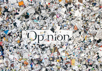 Newspaper confetti from above with the word Opinion