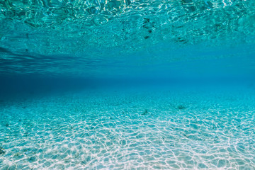 Tropical blue ocean water with sandy bottom underwater