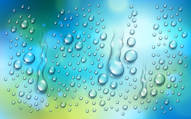 water rain drops or condensation over blurred green and blue nature background beyond the window, re