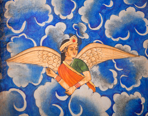 Wall Mural - Winged Indian girl in sari flying in the sky - ancient wall painting at Patwon Ki Haveli in Jaisalmer, Rajasthan, India