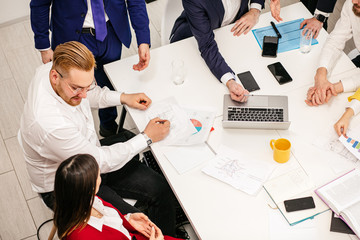 Wall Mural - active discussion, co-working of young business partners or colleagues in modern office, wearing formal wear, enjoy working together, brainstorm time