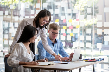 Group of young modern people in smart casual wear at meeting together to analyze and discussing business in the office.