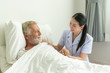 © Pornchai - Young nurse take care senior man on a bed, A nurse checking sernior man, Senior man happniess and smiling with nurse, Health care concept