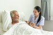 © Pornchai - Young nurse take care senior man on a bed, A nurse checking sernior man, Senior man happniess and smiling with nurse, Health care concept