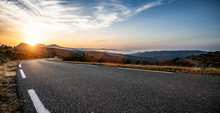 Empty Long Mountain Road To The Horizon On A Sunny Summer Day At Bright Sunset