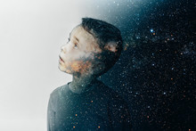 A Small Child Imagines Himself To Be An Astronaut In An Astronaut's Helmet. Elements Of This Image Furnished By NASA