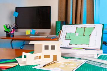 Poster - house with a flat roof on a computer table. preparation of documents for the contractor. floor plan 