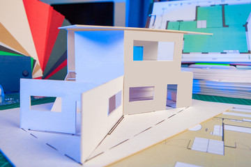 Poster - house project and blueprints on the table. design documentation next to the layout of the house. dev