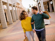 © BGStock72 - Young smiling couple shopping in an urban street