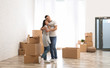 © New Africa - Happy couple in room with cardboard boxes on moving day