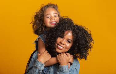 happy mother's day! Adorable sweet young afro-american mother with cute little daugh.