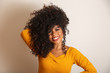 © Brastock Images - Young afro-american woman with curly hair looking at camera and smiling. Cute afro girl with curly hair smiling looking at camera.