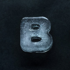 Fototapete - Melting speech. Alphabet's shiny and well-structured letters made out of ice isolated on dark studio background. Collect for combine in words. Copyspace to insert your advertising.