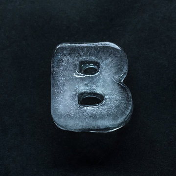 Melting speech. Alphabet's shiny and well-structured letters made out of ice isolated on dark studio background. Collect for combine in words. Copyspace to insert your advertising.