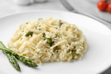 Delicious risotto with asparagus in plate, closeup