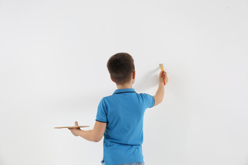 Sticker - Little child painting on white wall indoors