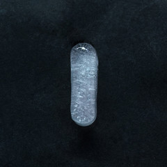 Fototapete - Melting speech. Alphabet's shiny and well-structured letters made out of ice isolated on dark studio background. Collect for combine in words. Copyspace to insert your advertising.