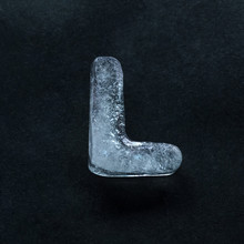 Melting Speech. Alphabet's Shiny And Well-structured Letters Made Out Of Ice Isolated On Dark Studio Background. Collect For Combine In Words. Copyspace To Insert Your Advertising.