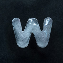 Fototapete - Melting speech. Alphabet's shiny and well-structured letters made out of ice isolated on dark studio background. Collect for combine in words. Copyspace to insert your advertising.