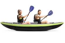 Profile Shot Of A Young Man And Woman With Safety Vest Paddling In A Canoe